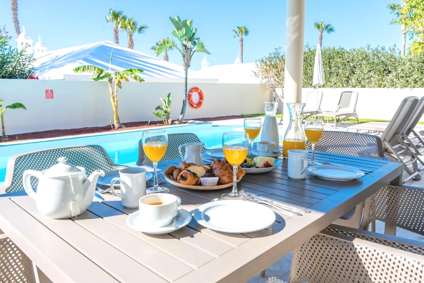 Mesa con desayuno y bebidas en el patio del hotel Villas Alondra en Puerto del Carmen